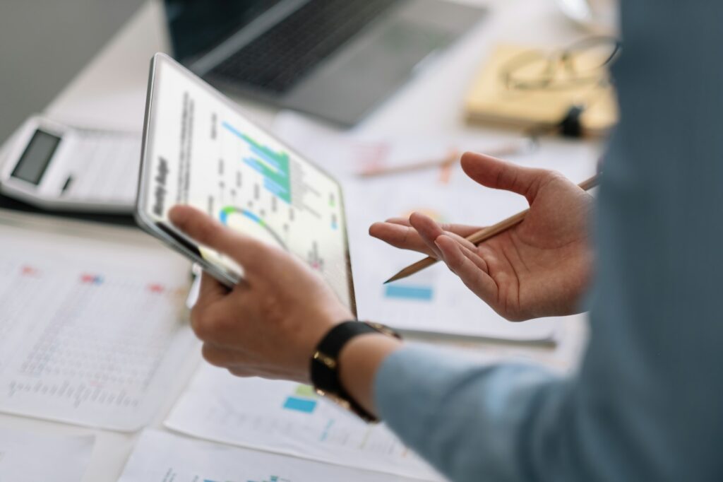 Meeting business team advisor about charts on digital tablet, financial graphs showing results